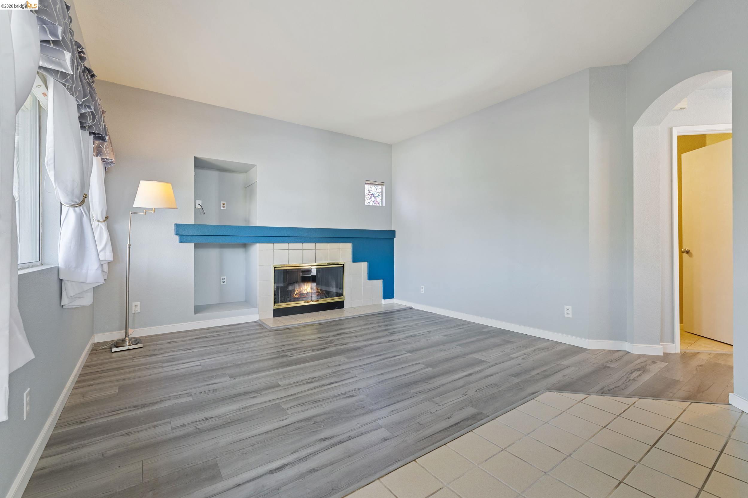 4924 Stirrup Way Antioch, CA 94531 - Photo 13 of 40 a view of an empty room with wooden floor and a window