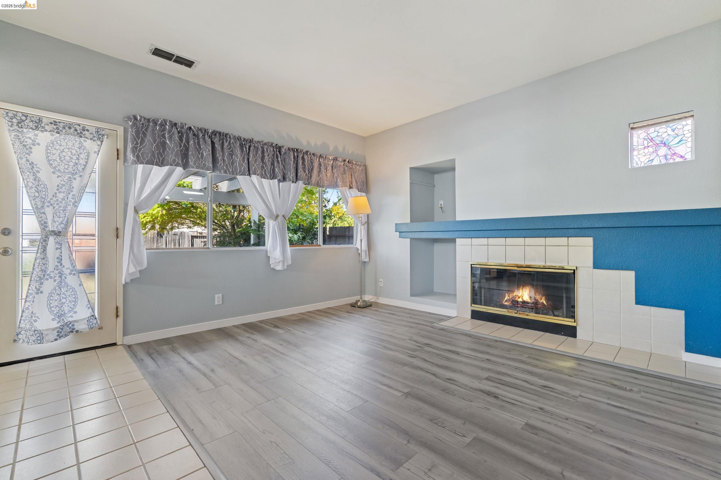 4924 Stirrup Way Antioch, CA 94531 - Photo 14 of 40 an empty room with windows and fireplace