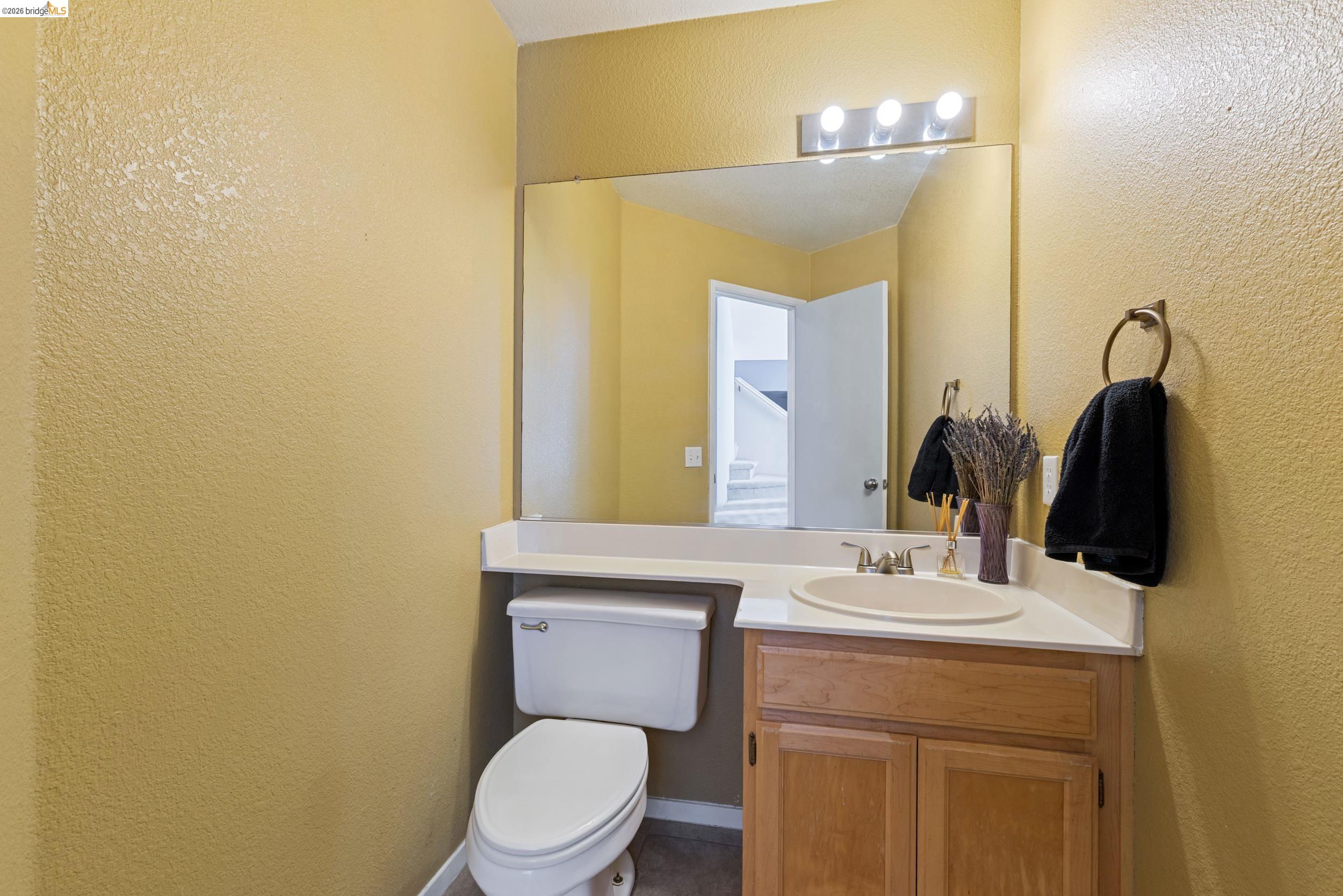 4924 Stirrup Way Antioch, CA 94531 - Photo 15 of 40 a bathroom with a toilet sink and mirror