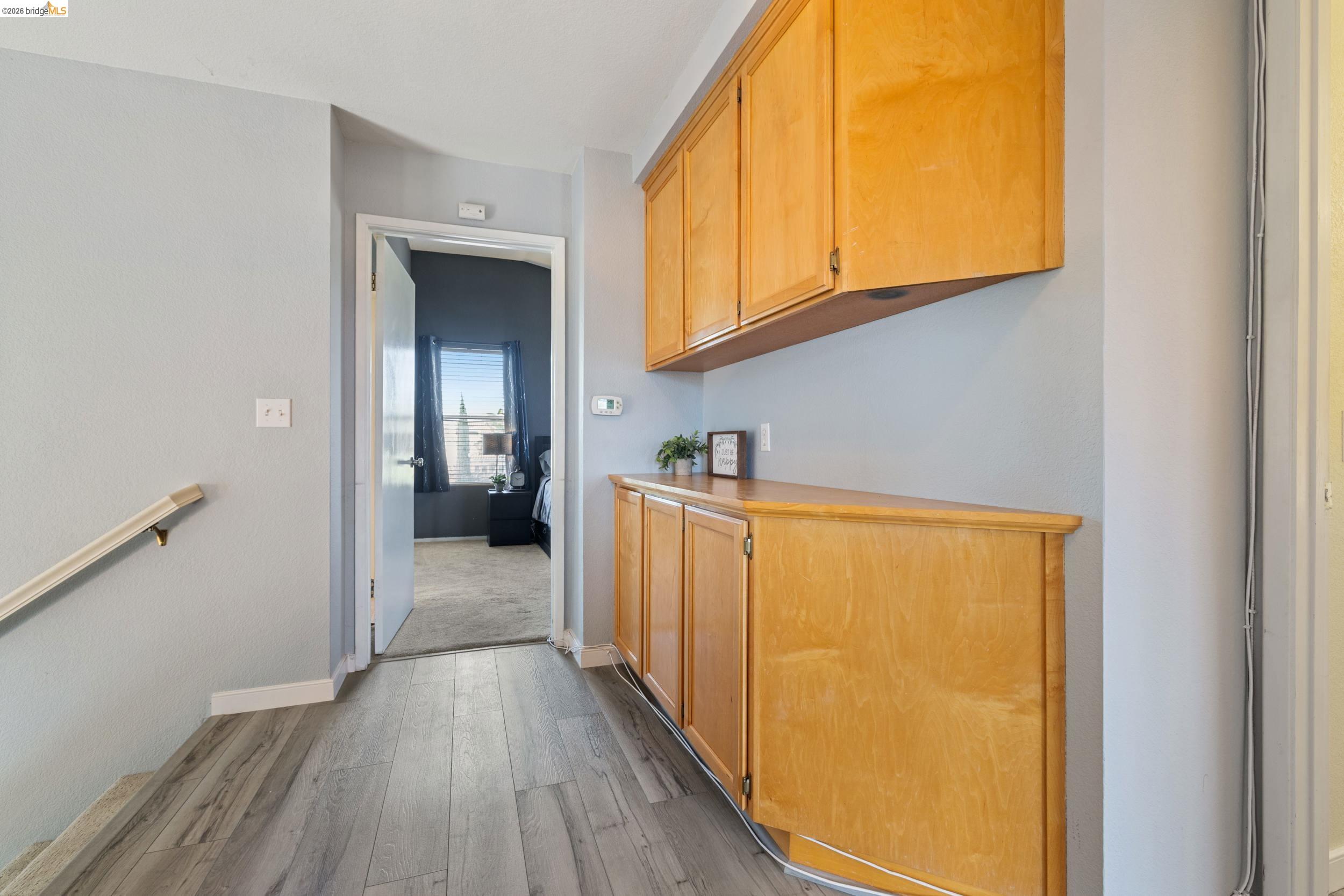 4924 Stirrup Way Antioch, CA 94531 - Photo 17 of 40 a view of a hallway with wooden floor and a cabinet
