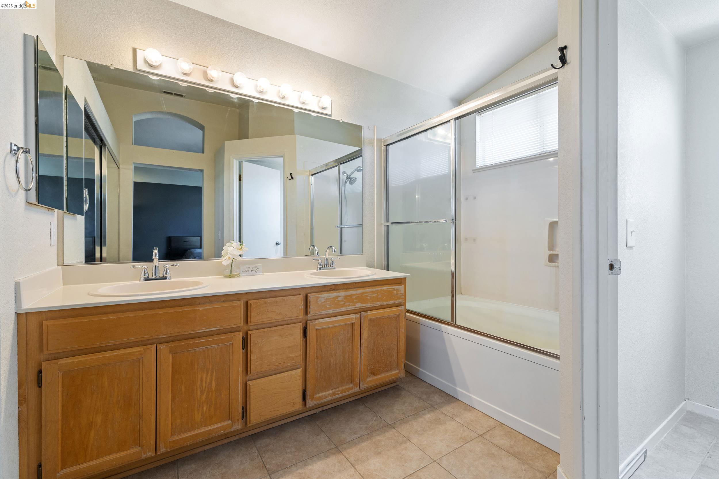 4924 Stirrup Way Antioch, CA 94531 - Photo 27 of 40 a spacious bathroom with a double vanity sink and a mirror