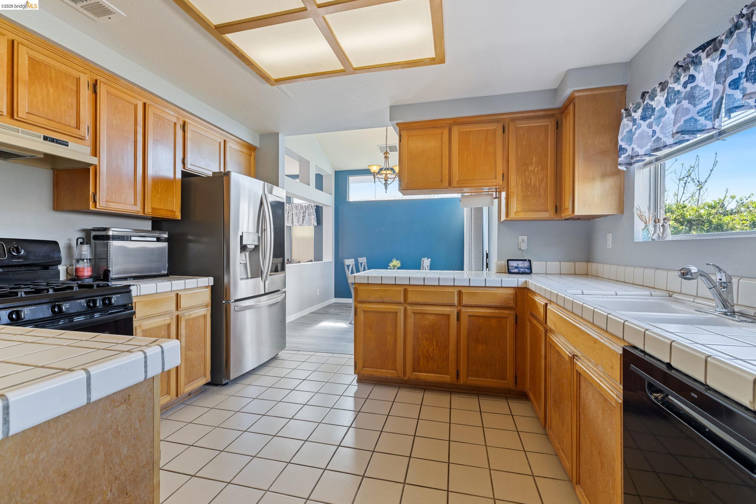 4924 Stirrup Way Antioch, CA 94531 - Photo 9 of 40 a kitchen with stainless steel appliances granite countertop a refrigerator and a stove top oven