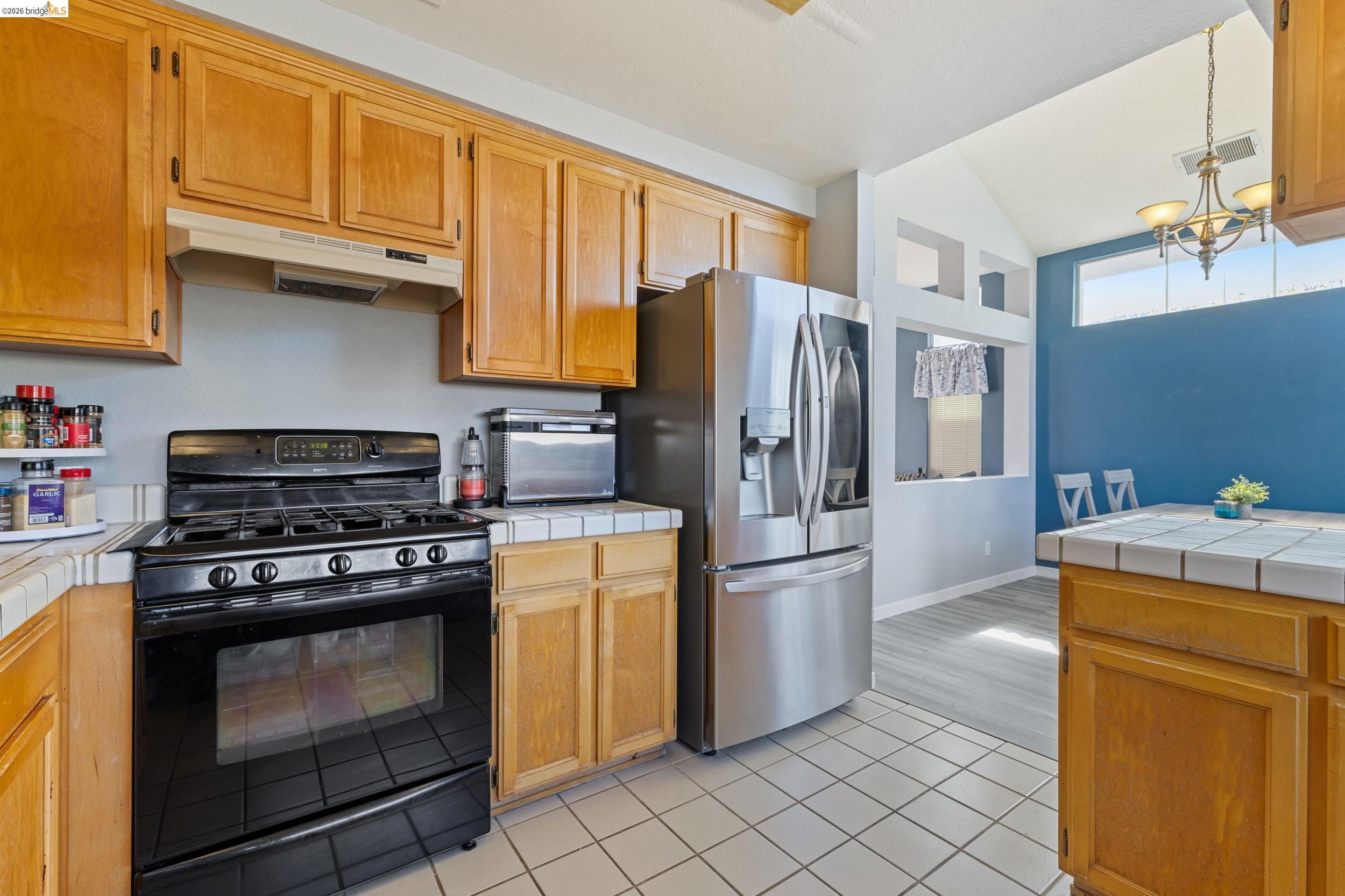 4924 Stirrup Way Antioch, CA 94531 - Photo 10 of 40 a kitchen with stainless steel appliances granite countertop a refrigerator stove and cabinets