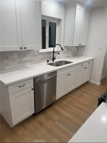 a kitchen with sink and cabinets