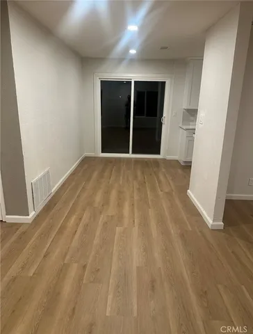 a view of a hallway with wooden floor