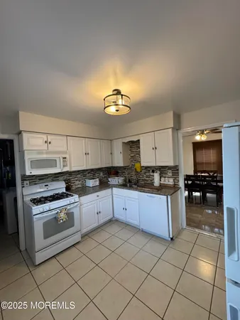a kitchen with a stove a sink and a refrigerator