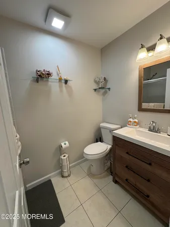 a bathroom with a toilet a sink and mirror