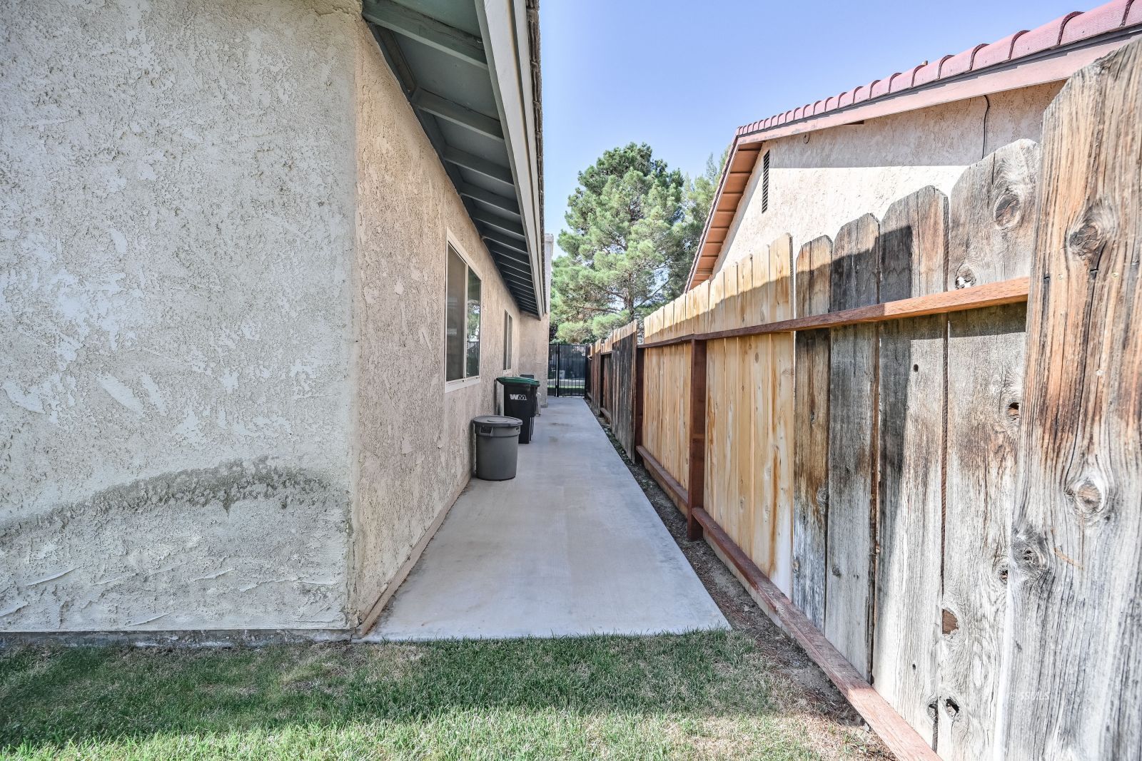 412 Lorene Court Ridgecrest, CA 93555 - Photo 30 of 31 a view of a pathway of a house with backyard and wooden fence
