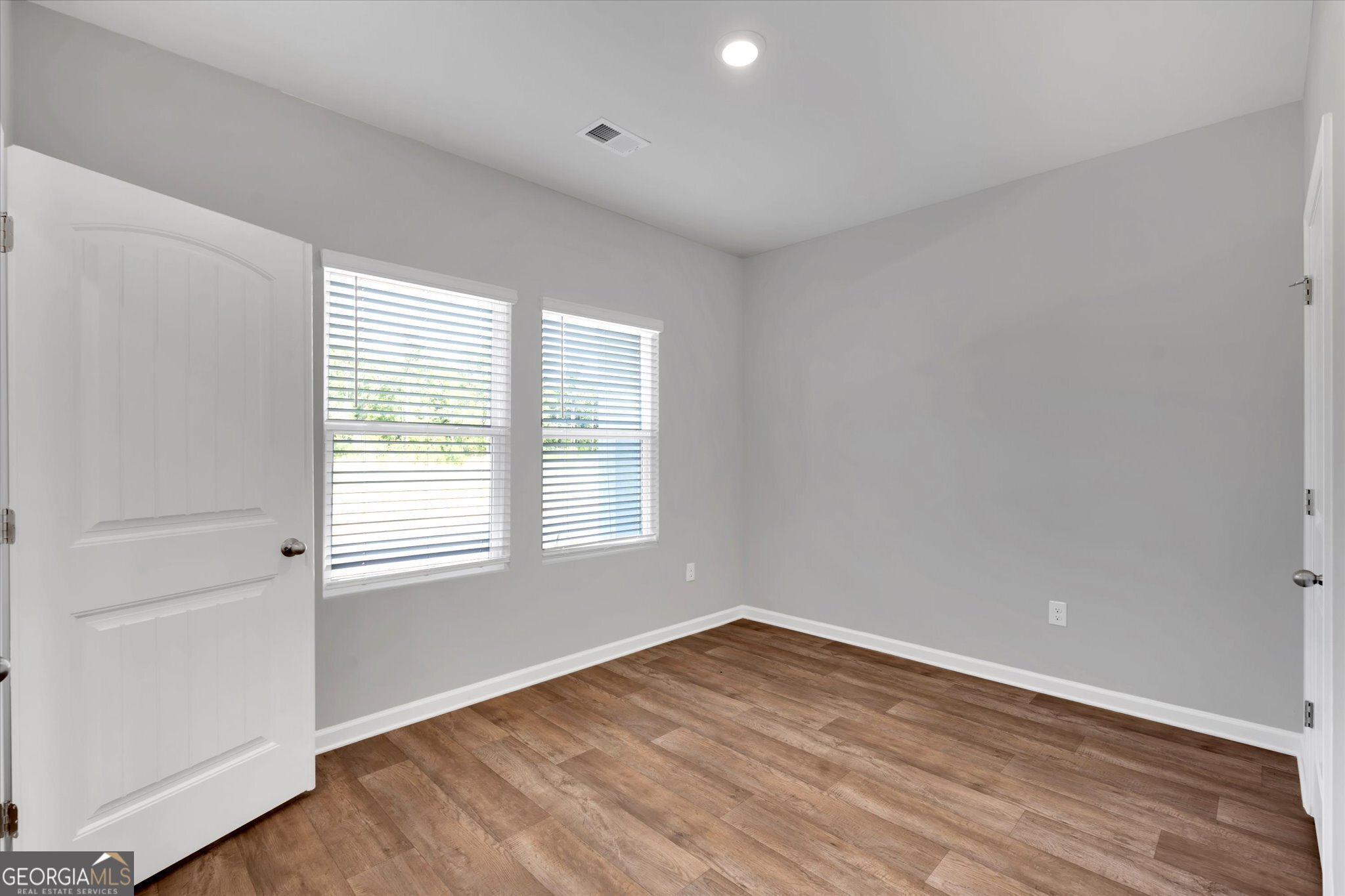 5357 Tolar Road South Fulton, GA 30213 - Photo 2 of 27 an empty room with wooden floor and windows