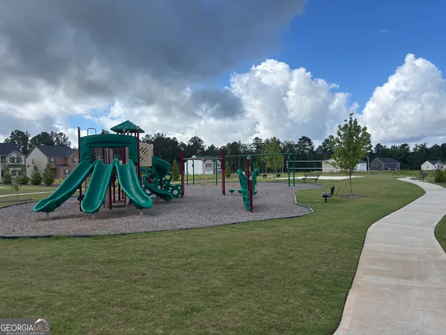 a view of outdoor space with playground and green space