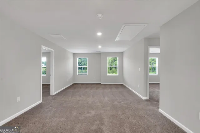 an empty room with windows and closet