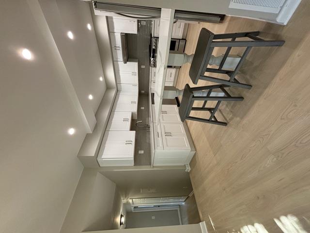 a kitchen with a sink a stove a refrigerator and a microwave