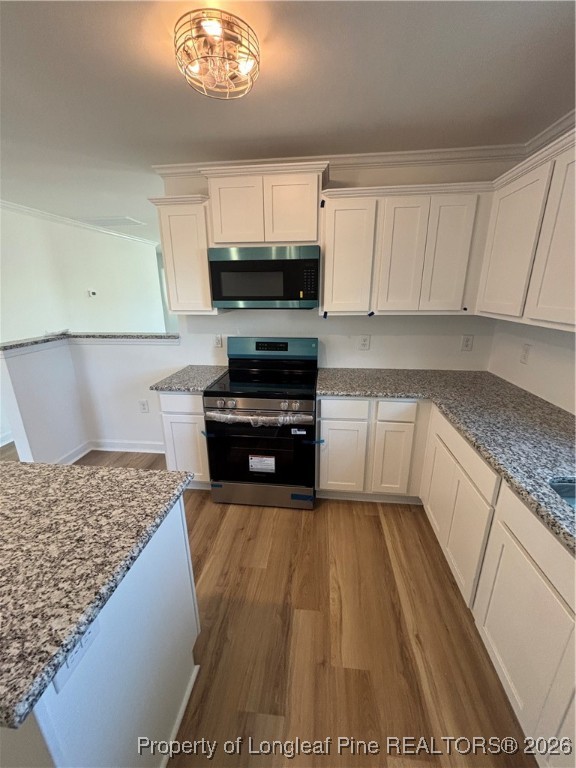 237 Musket Lane Raeford, NC 28376 - Photo 7 of 18 a kitchen with kitchen island granite countertop a sink cabinets and stainless steel appliances