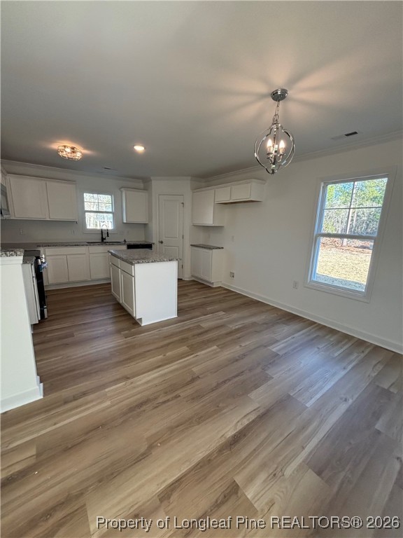 237 Musket Lane Raeford, NC 28376 - Photo 8 of 18 an empty room with kitchen appliances and a ceiling fan