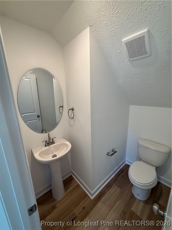 237 Musket Lane Raeford, NC 28376 - Photo 9 of 18 a bathroom with a toilet a sink and mirror