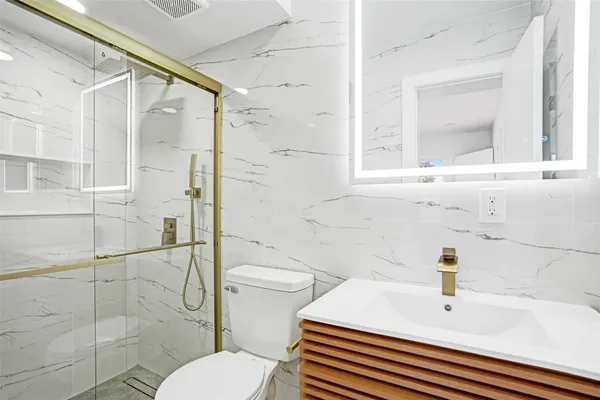 a bathroom with a sink toilet and shower