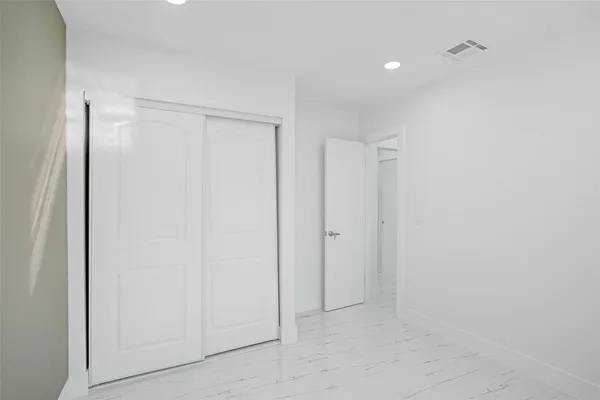 a bathroom with a sink mirror vanity and toilet