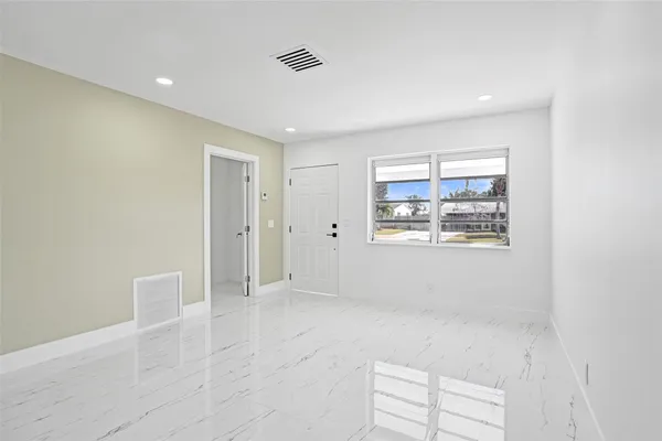 a view of an empty room with a window