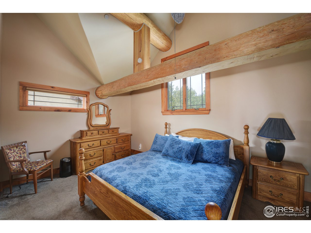500 Ridge Road Ward, CO 80481 - Photo 16 of 31 a bedroom with a bed and wooden floor