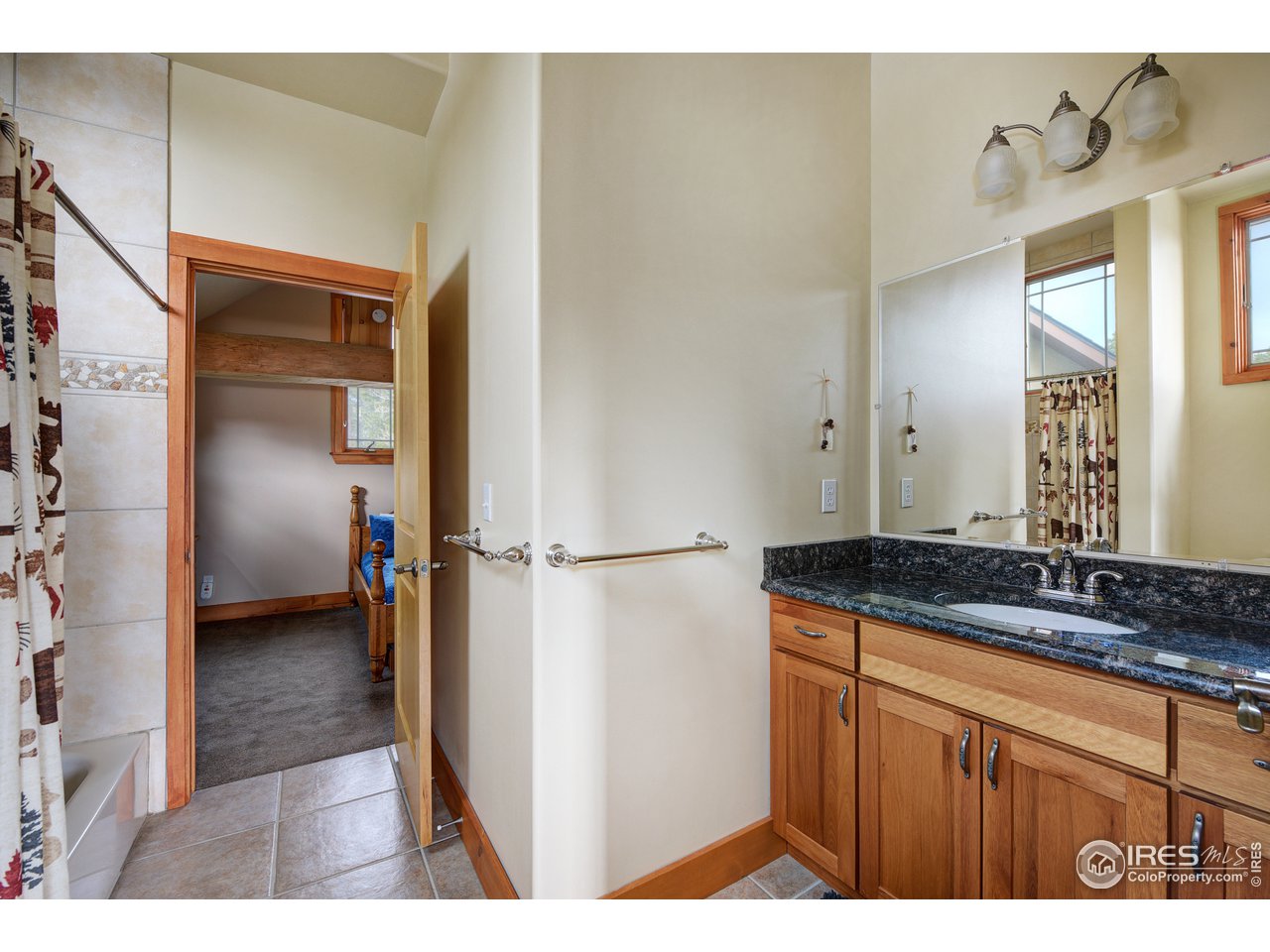 500 Ridge Road Ward, CO 80481 - Photo 17 of 31 a en suite bathroom with a granite countertop sink and a mirror
