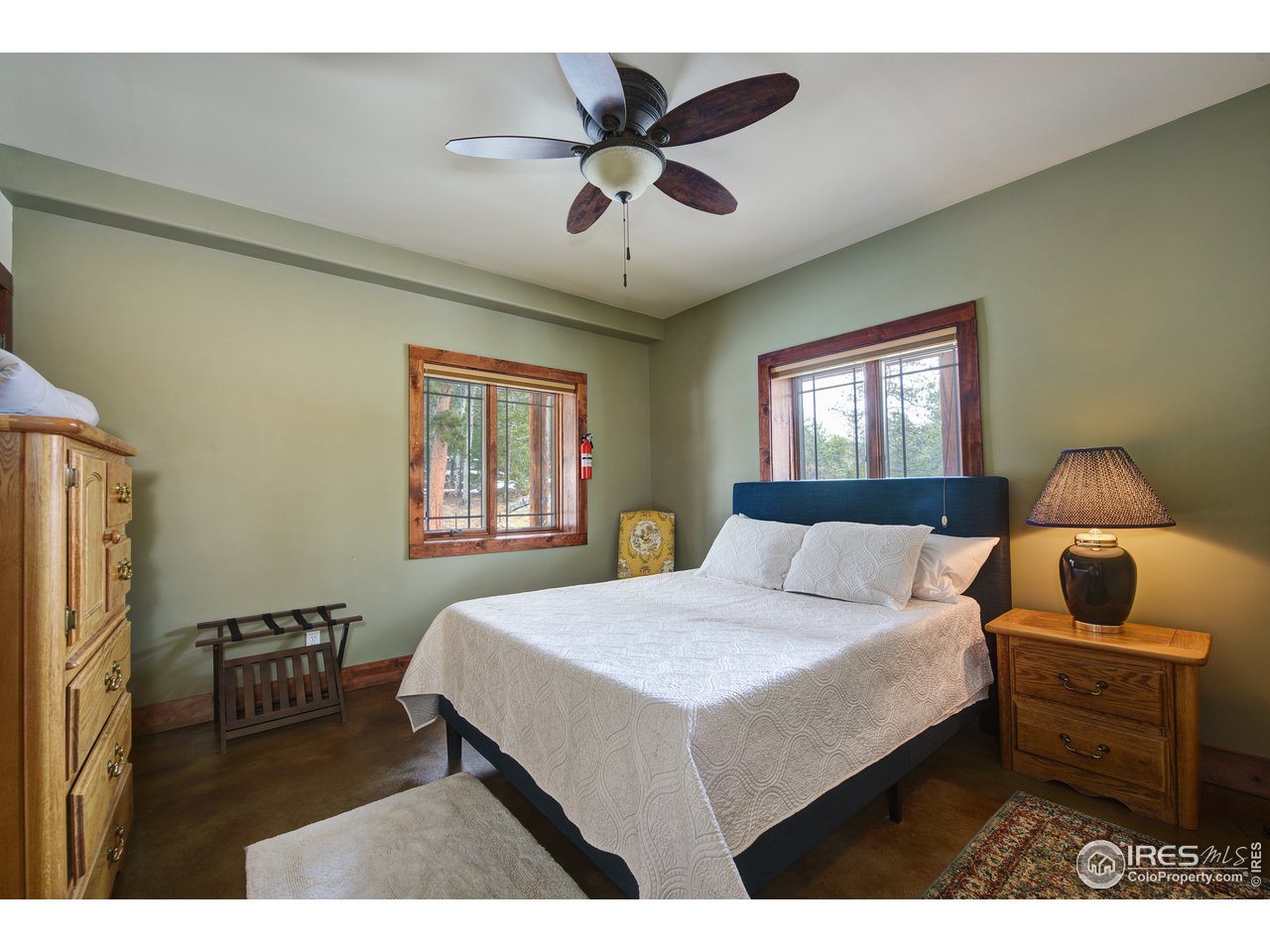 500 Ridge Road Ward, CO 80481 - Photo 19 of 31 a bedroom with a bed and a chandelier