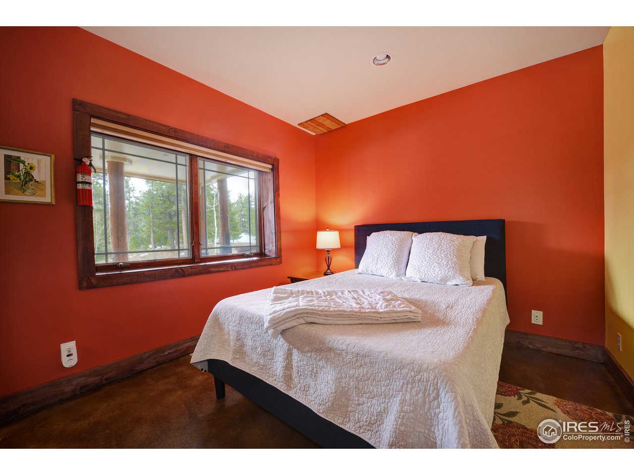 500 Ridge Road Ward, CO 80481 - Photo 23 of 31 a bedroom with a bed and wooden floor