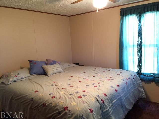 12846 Taft Road Clinton, IL 61727 - Photo 9 of 21 a bedroom with a bed and a window