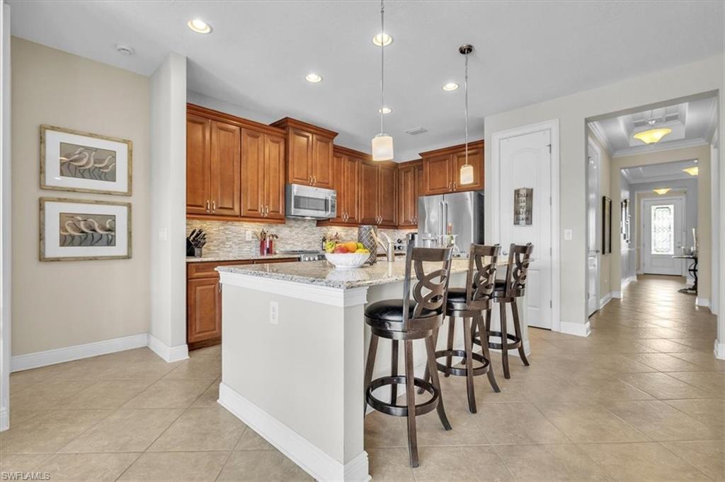 16480 Windsor Way Alva, FL 33920 - Photo 15 of 48 a open kitchen with stainless steel appliances granite countertop a refrigerator and a stove top oven