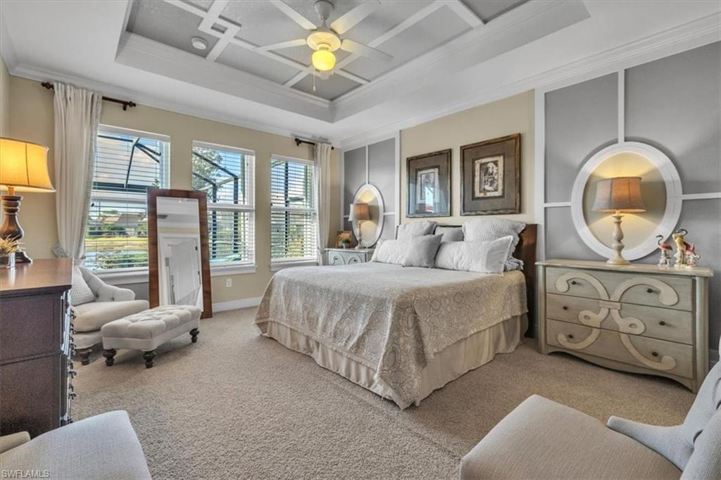 16480 Windsor Way Alva, FL 33920 - Photo 20 of 48 a spacious bedroom with a bed a couch and a chandelier