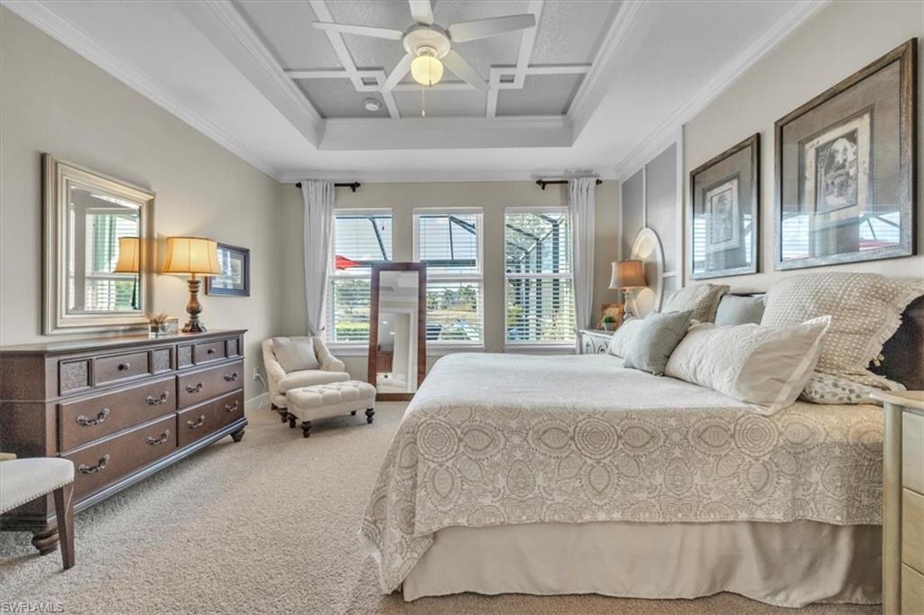 16480 Windsor Way Alva, FL 33920 - Photo 21 of 48 a spacious bedroom with a bed a dresser and large windows