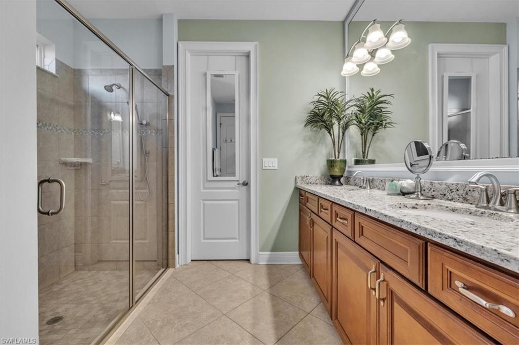 16480 Windsor Way Alva, FL 33920 - Photo 22 of 48 a bathroom with a granite countertop sink a large mirror and a shower