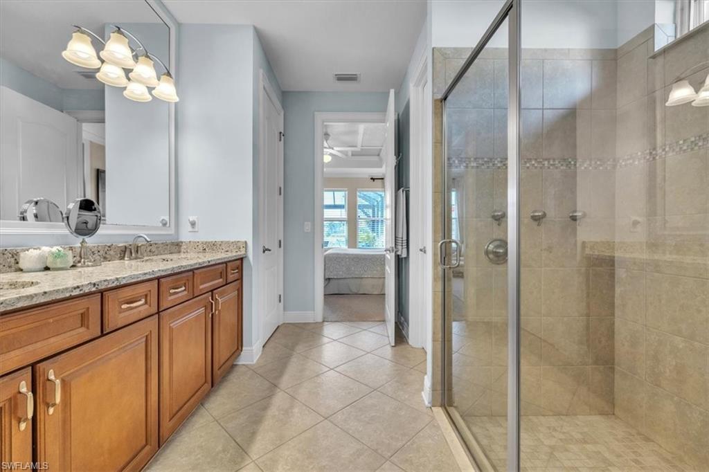 16480 Windsor Way Alva, FL 33920 - Photo 23 of 48 a bathroom with a granite countertop sink a mirror and a shower