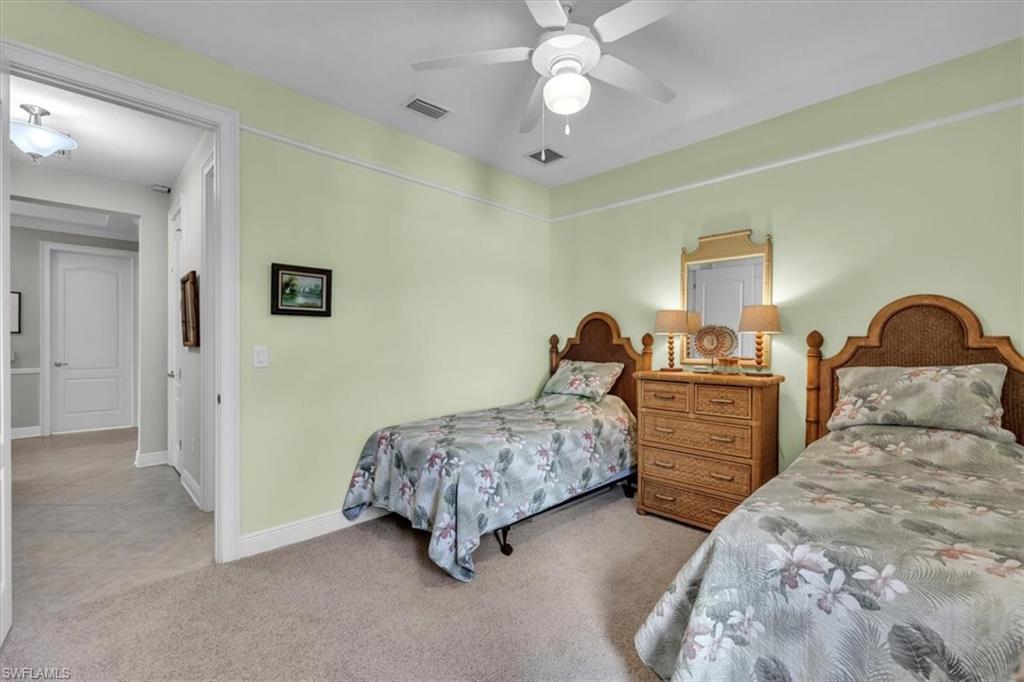 16480 Windsor Way Alva, FL 33920 - Photo 26 of 48 a bedroom with two beds and a chandelier