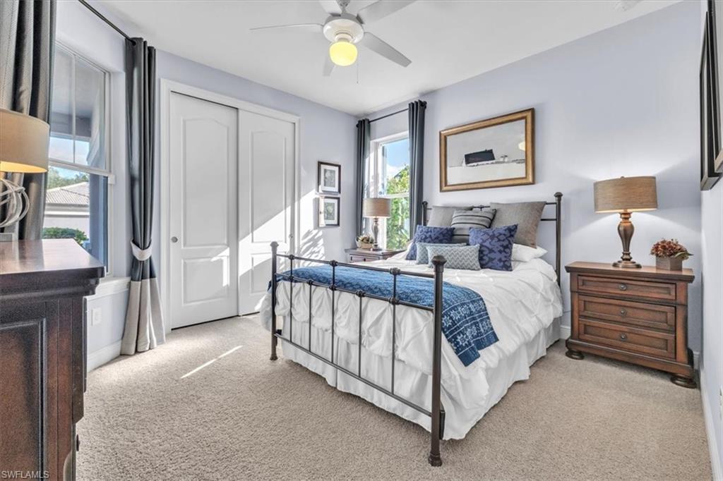 16480 Windsor Way Alva, FL 33920 - Photo 30 of 48 a bed room with a bed and a chandelier