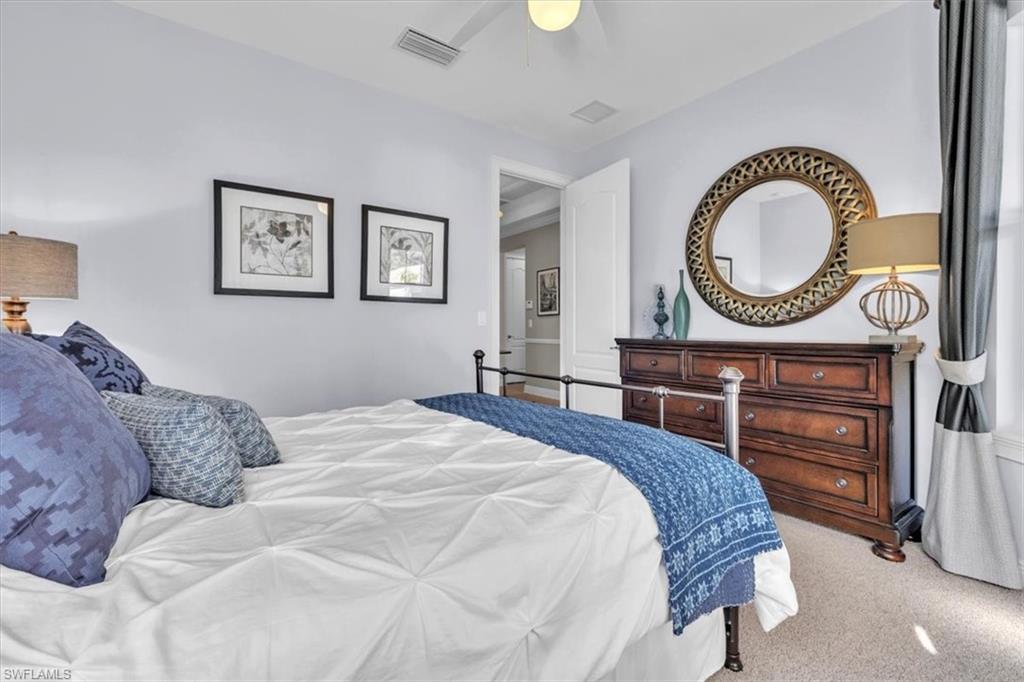 16480 Windsor Way Alva, FL 33920 - Photo 31 of 48 a bedroom with a bed a mirror and a table