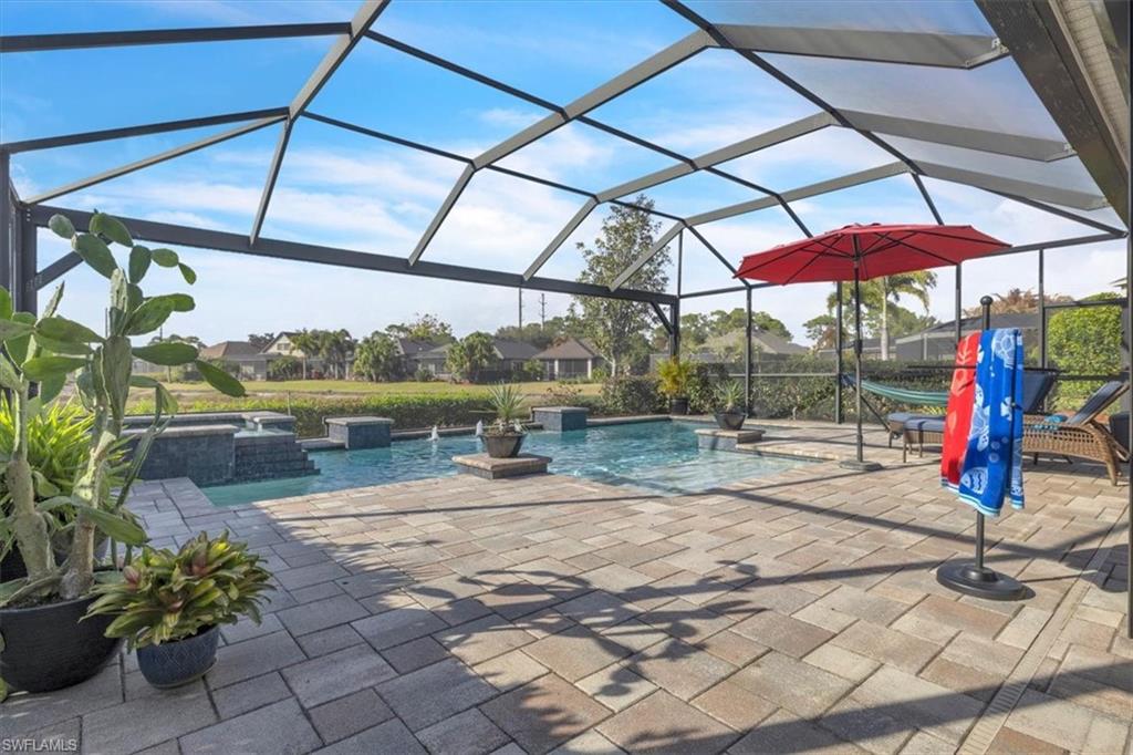 16480 Windsor Way Alva, FL 33920 - Photo 36 of 48 a view of a tennis ground with a table and chairs under an umbrella
