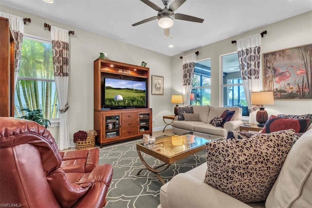 16480 Windsor Way Alva, FL 33920 - Photo 10 of 48 a living room with furniture a flat screen tv and a large window