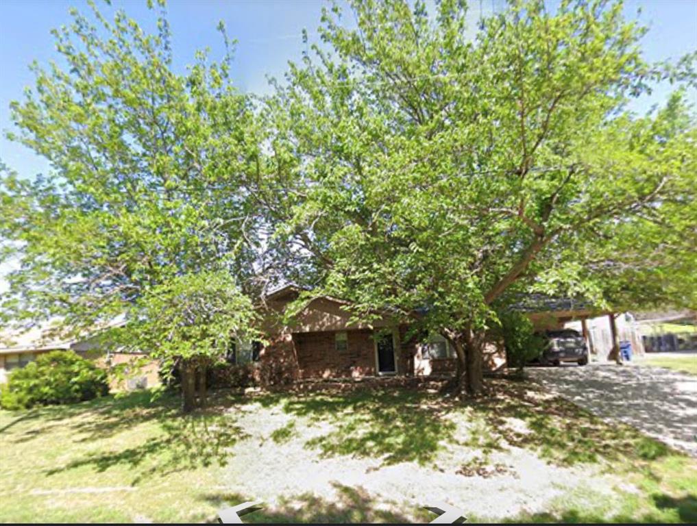 1000 North Chico Street Decatur, TX 76234 - Photo 1 of 1 a view of a yard with plants and trees