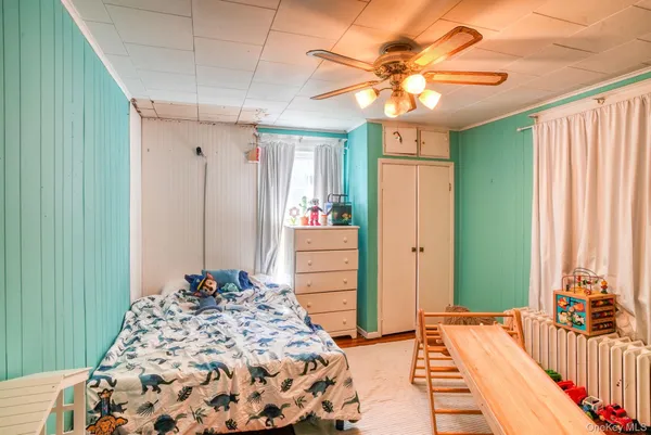 a bedroom with a bed and a chandelier