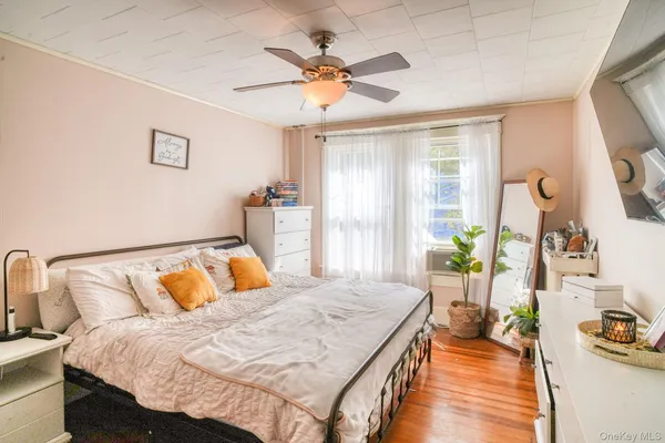 a bedroom with a bed and ceiling fan