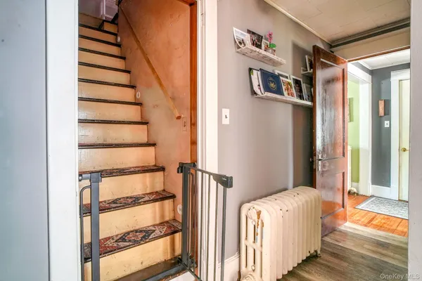 a view of a hallway with wooden floor and entryway