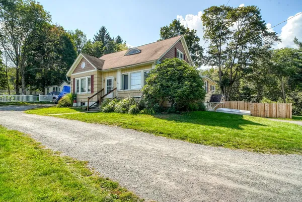 a front view of house with yard and green space
