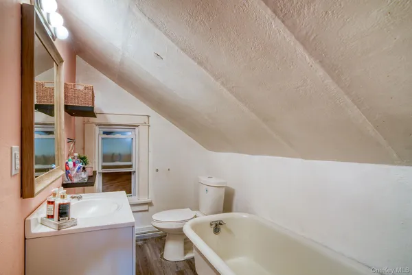 a bathroom with a sink mirror vanity and toilet