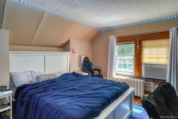 a bedroom with a bed and a window