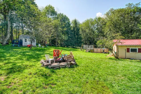 a view of a chair and table in the garden