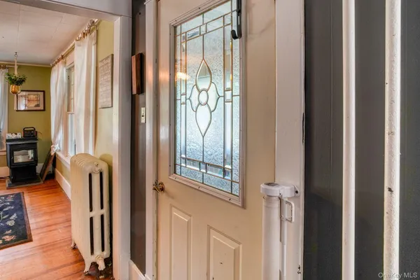 a view of a hallway with furniture and a window