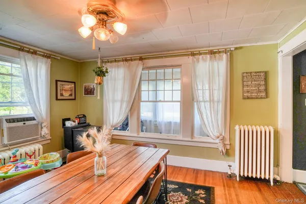 a view of a room with furniture and wooden floor