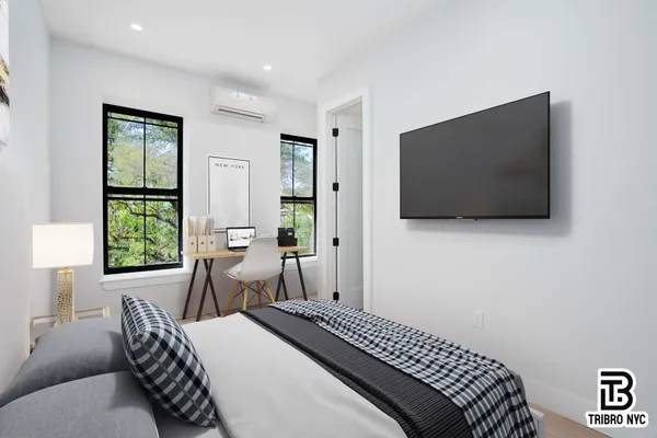 a bedroom with a bed and a flat screen tv