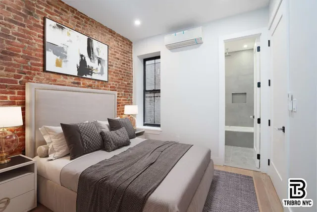 a bedroom with a bed and a painting on the wall