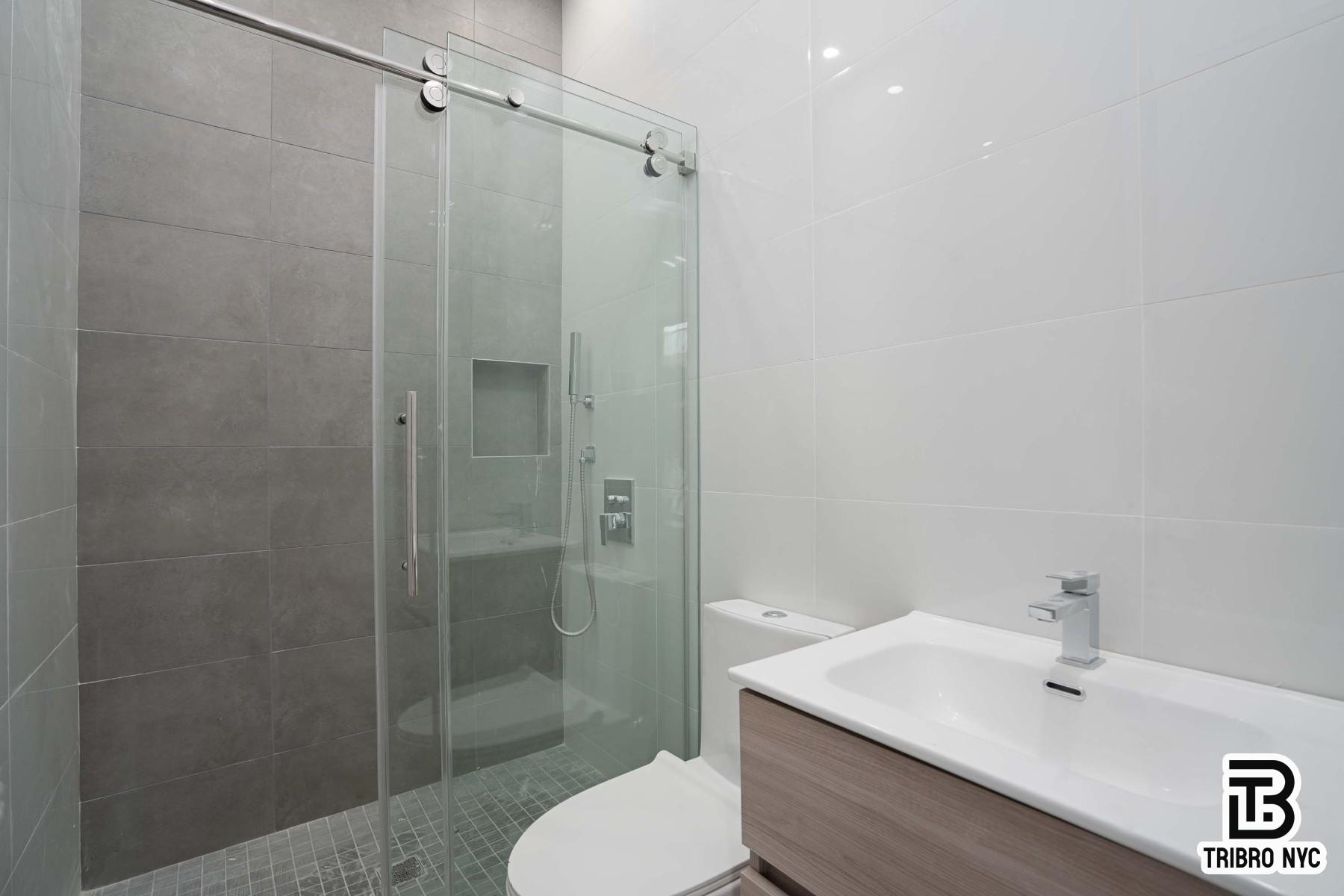 62-15 Catalpa Avenue, Unit 3A Queens, NY 11385 - Photo 6 of 9 a bathroom with a shower a toilet and sink